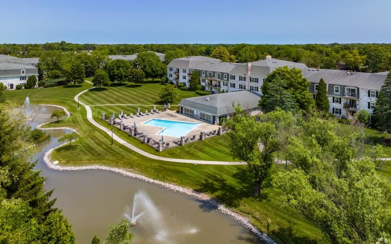 a large building with a pool in front of it