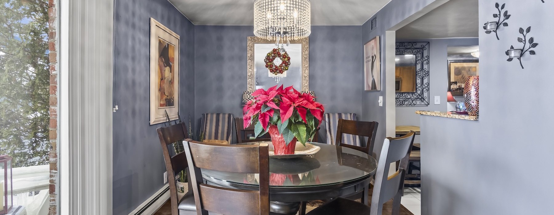 a dining room table with a chandelier and chairs