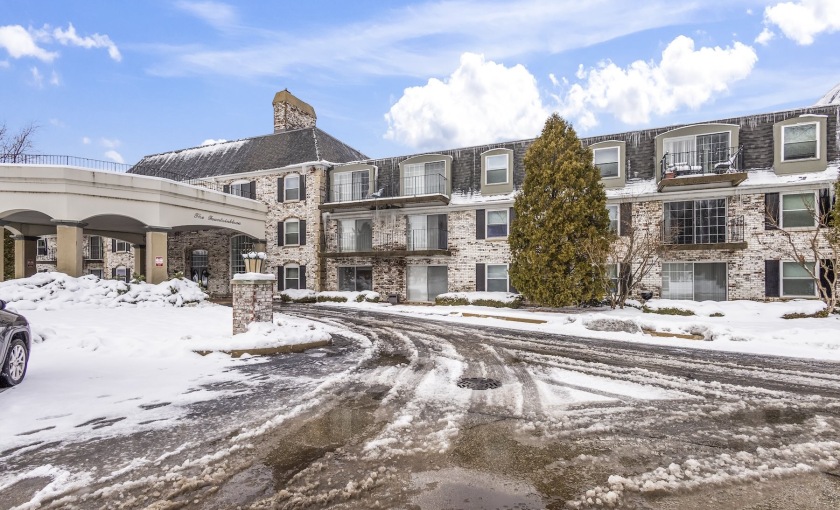 a large building with a driveway and snow