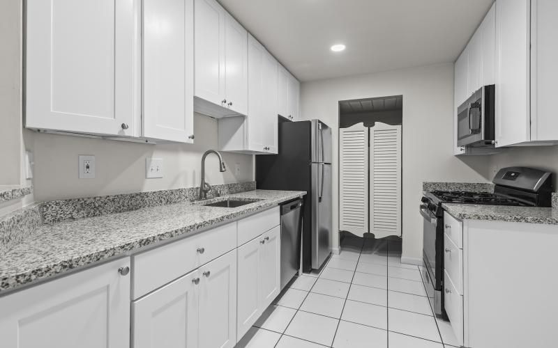a kitchen with white cabinets