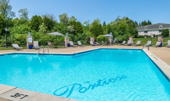 a pool with chairs around it