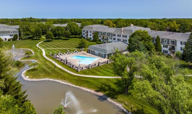 a large building with a pool in front of it