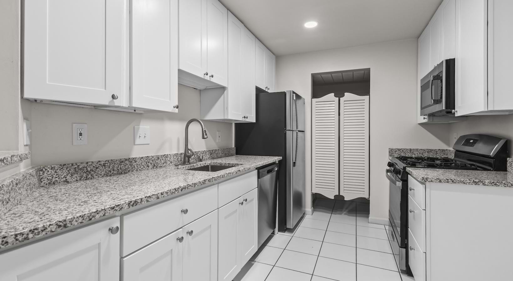 a kitchen with white cabinets