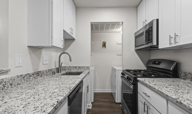 a kitchen with white cabinets